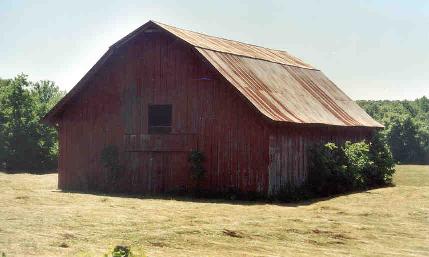 Hwy 70 north to Story. The barn will be on your right and the Whittington Cemetery will be just ahead on the left.