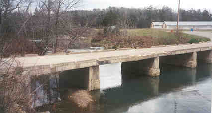 Brushy Bridge with chicken houses in the background.