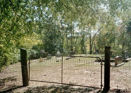 A small cemetery sitting on a knoll.