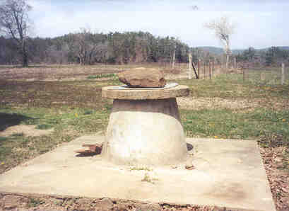 Down Brushy Rd, Oden.  The old well house with its v shaped roof and pulley system is long gone.Today right beside it is a modern well house to cover an electric pump so the pipes don't freeze in winter.